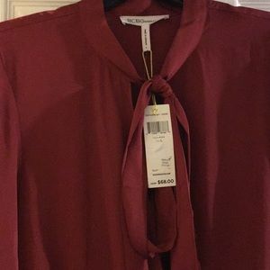 Blouse tie at the neck. Like a burgundy color